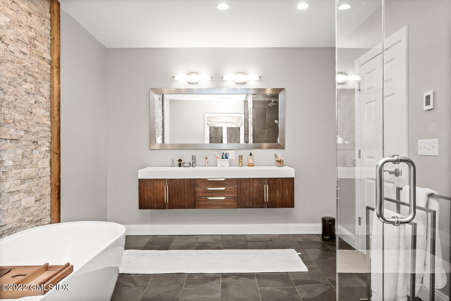 442 Riversville Road Greenwich, CT 06831 - Photo 15 of 29 a spacious bathroom with a tub shower and mirror