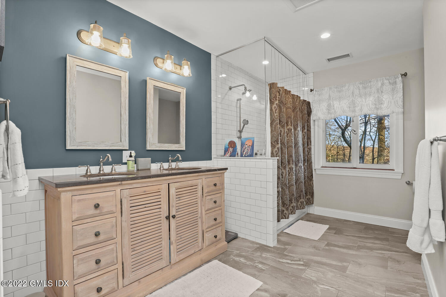 442 Riversville Road Greenwich, CT 06831 - Photo 19 of 29 a spacious bathroom with a granite countertop sink mirror and a