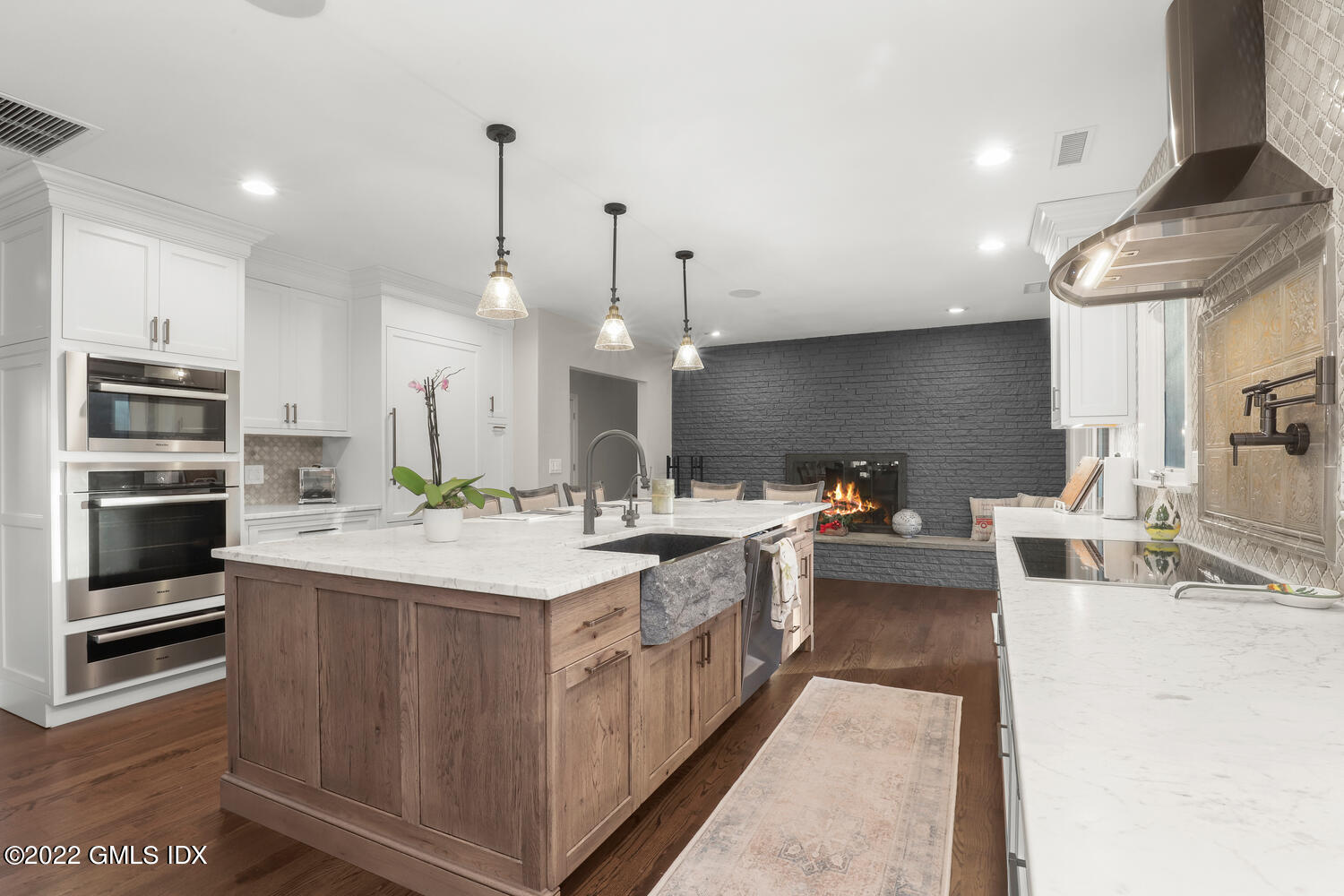 442 Riversville Road Greenwich, CT 06831 - Photo 8 of 29 a large kitchen with stainless steel appliances a stove and more cabinets