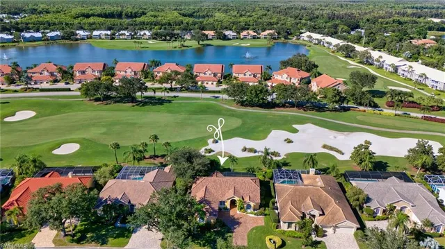 an aerial view of a houses with outdoor space lake view and mountain view in back