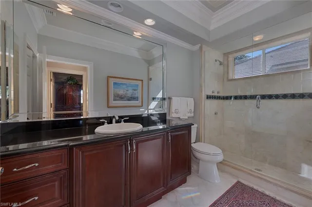 a bathroom with a granite countertop sink toilet and shower