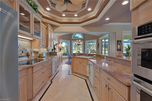 a large kitchen with stainless steel appliances lots of counter space and a sink