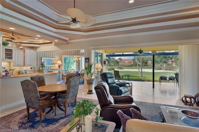 a dining room with furniture and a floor to ceiling window