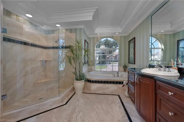 a spacious bathroom with a glass shower door and a bathtub