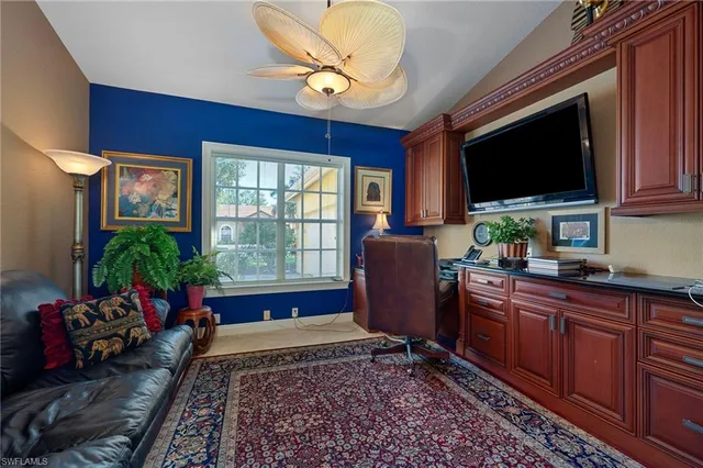 a living room with furniture flat screen tv and potted plant