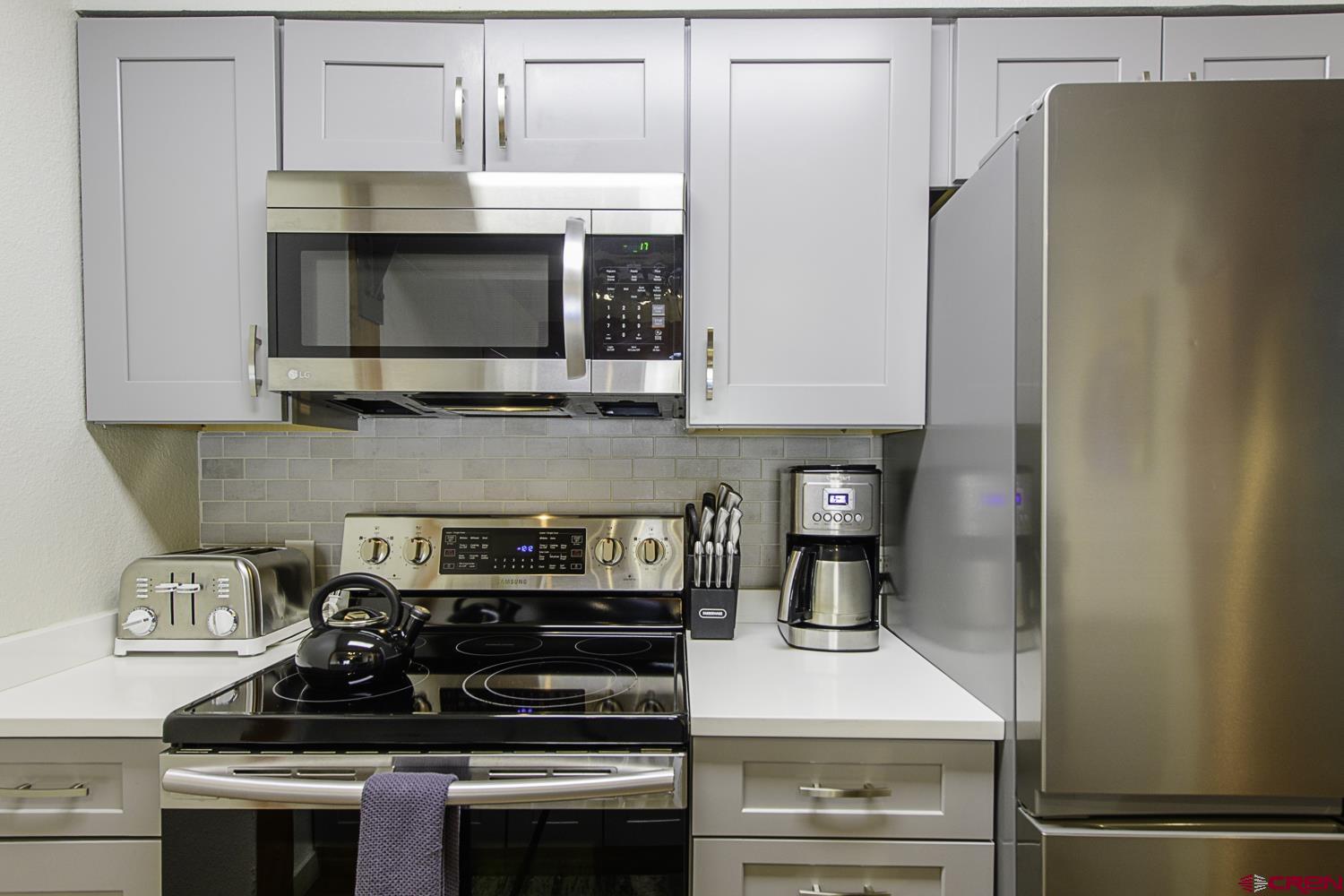 25 Emmons Road, Unit 37 Crested Butte, CO 81225 - Photo 12 of 28 a kitchen with stainless steel appliances a stove and a microwave