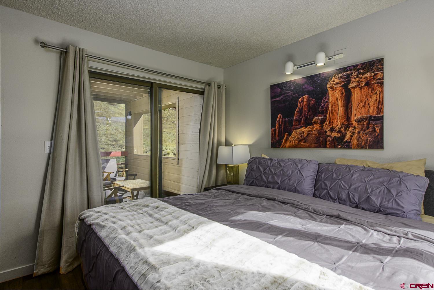 25 Emmons Road, Unit 37 Crested Butte, CO 81225 - Photo 16 of 28 a bedroom with a bed and a dresser