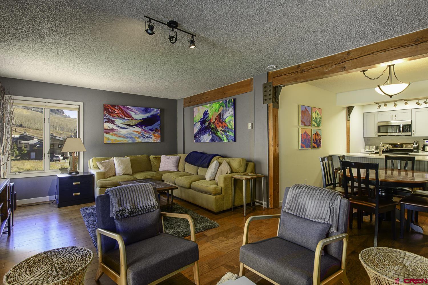 25 Emmons Road, Unit 37 Crested Butte, CO 81225 - Photo 2 of 28 a living room with furniture and a flat screen tv