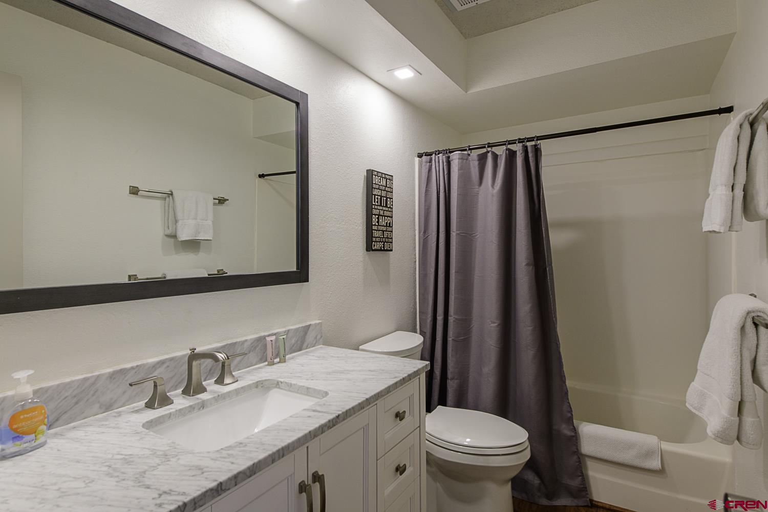 25 Emmons Road, Unit 37 Crested Butte, CO 81225 - Photo 22 of 28 a bathroom with a granite countertop sink toilet and shower