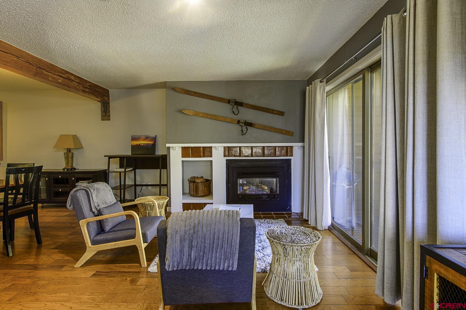 25 Emmons Road, Unit 37 Crested Butte, CO 81225 - Photo 3 of 28 a living room with furniture and a fireplace