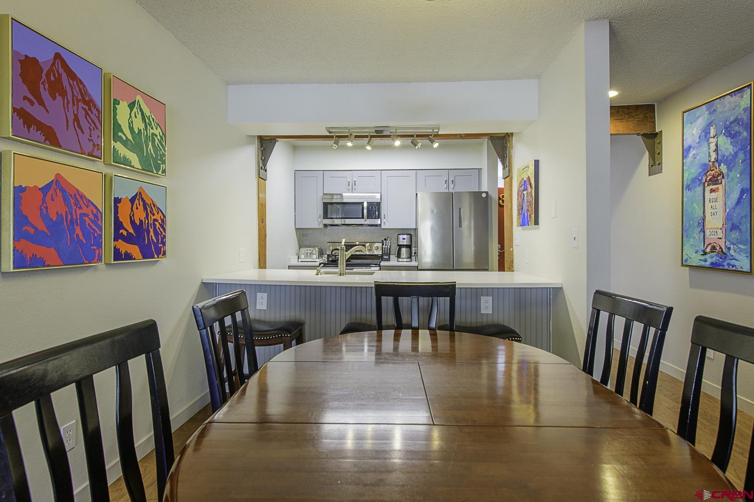 25 Emmons Road, Unit 37 Crested Butte, CO 81225 - Photo 8 of 28 a view of a dining room with furniture a chandelier and wooden floor