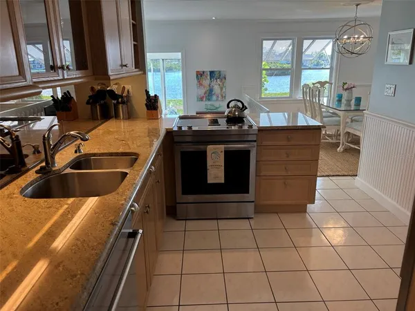 a kitchen with a sink and a stove top oven