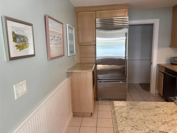 a kitchen with a refrigerator and a stove top oven