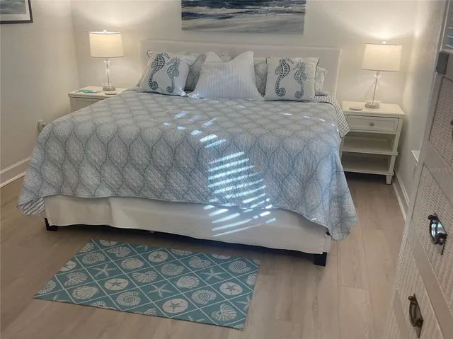 a bedroom with a bed and a night stand