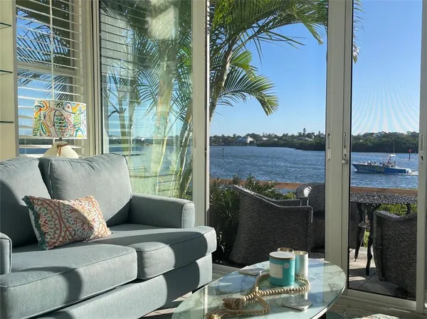 a living room with furniture and a floor to ceiling window