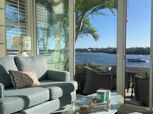 a living room with furniture and a floor to ceiling window