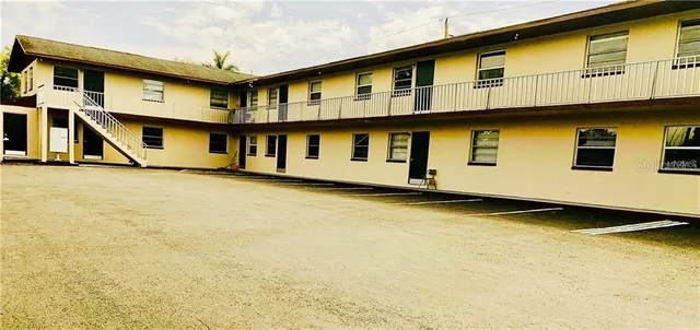 a front view of a building with blue swimming pool