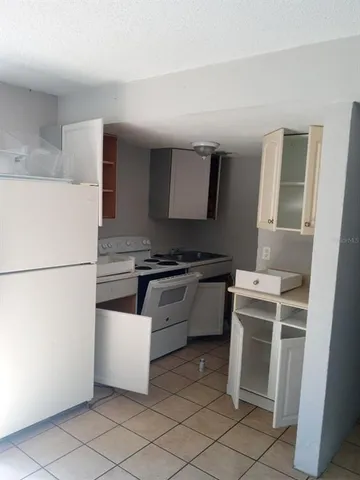 a kitchen with a stove and a refrigerator