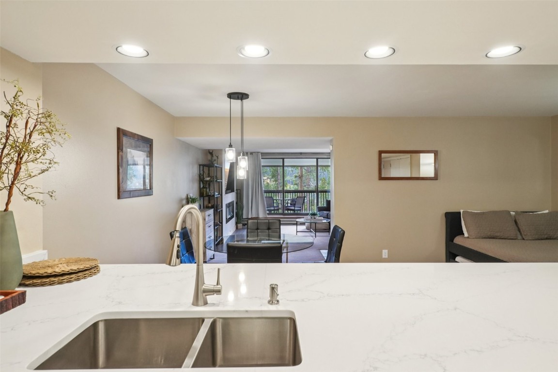 22097 Saints John Road, Unit 2506 Keystone, CO 80435 - Photo 14 of 47 Kitchen with recessed lighting, light stone counters, and decorative light fixtures