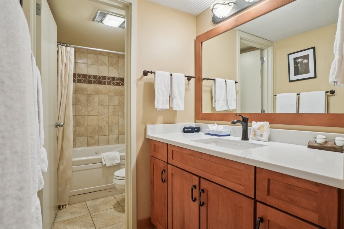 22097 Saints John Road, Unit 2506 Keystone, CO 80435 - Photo 20 of 47 Bathroom featuring light tile patterned flooring, vanity, and shower / tub combo