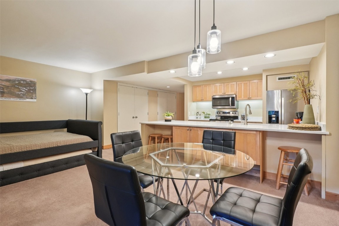 22097 Saints John Road, Unit 2506 Keystone, CO 80435 - Photo 9 of 47 Dining room featuring recessed lighting and light colored carpet