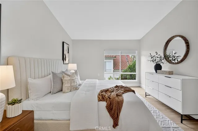 a bedroom with a bed and a large window