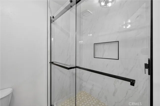 a bathroom with a shower and a mirror