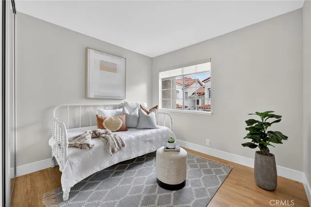 a living room with furniture flowerpot and wooden floor