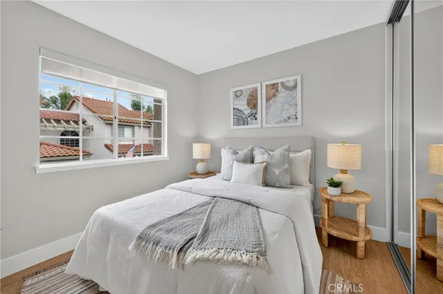 a bedroom with a bed and a painting on the wall