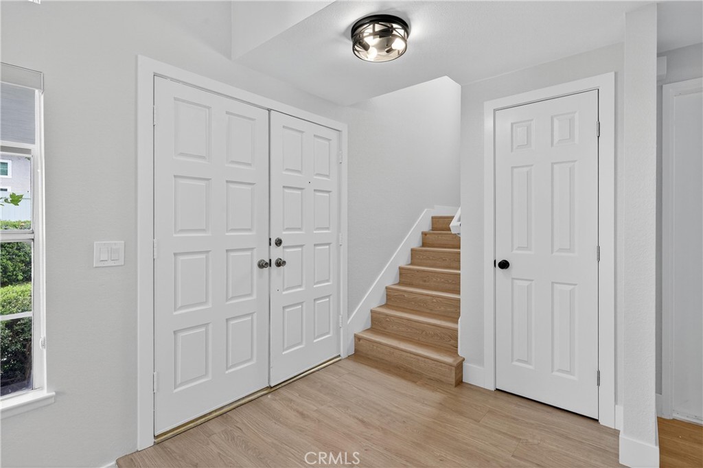 29 Carnation, Unit 64 Rancho Santa Margarita, CA 92688 - Photo 23 of 38 an empty room with wooden floor and entryway