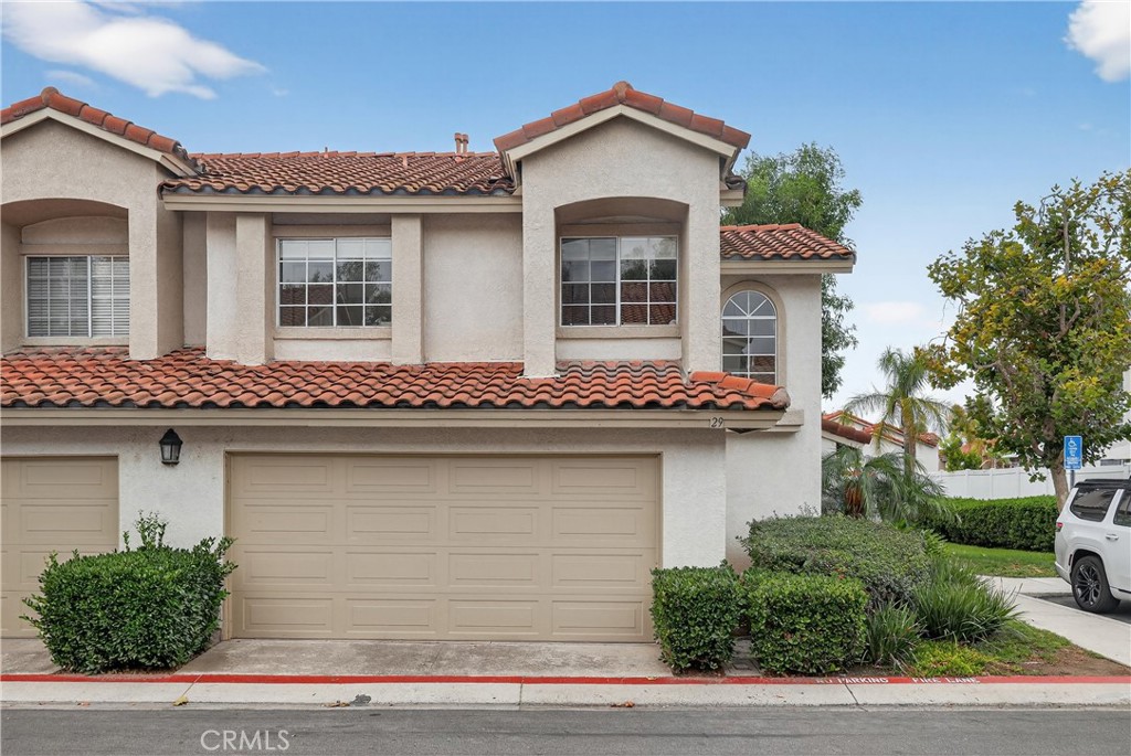 29 Carnation, Unit 64 Rancho Santa Margarita, CA 92688 - Photo 24 of 38 a front view of a house with garage