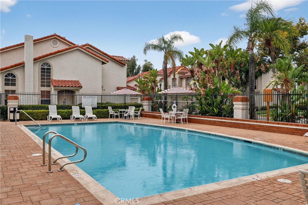 29 Carnation, Unit 64 Rancho Santa Margarita, CA 92688 - Photo 25 of 38 a swimming pool with outdoor seating and yard