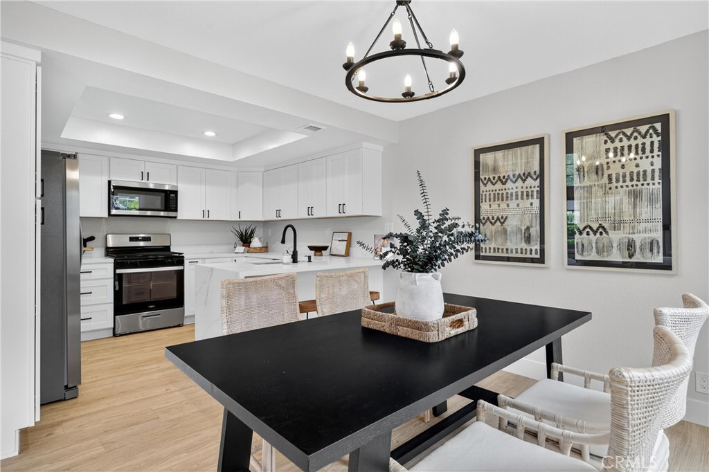 29 Carnation, Unit 64 Rancho Santa Margarita, CA 92688 - Photo 6 of 38 a kitchen with a dining table and chairs