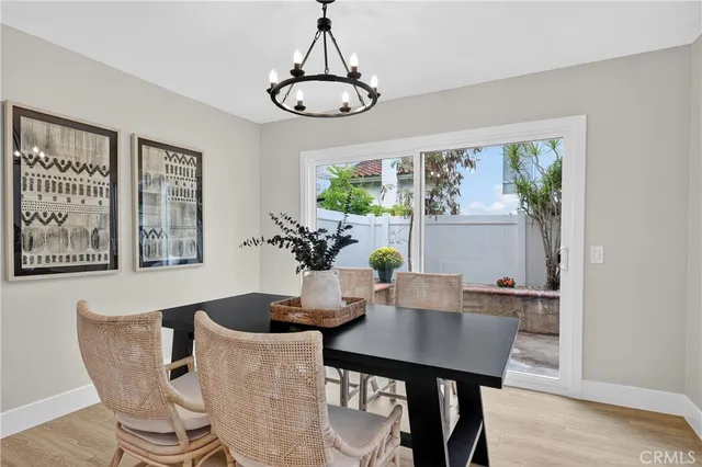 a dining room with furniture a window and a chandelier