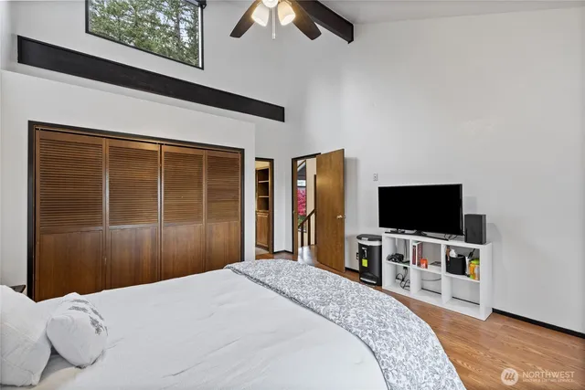 a bedroom with a bed and a flat screen tv