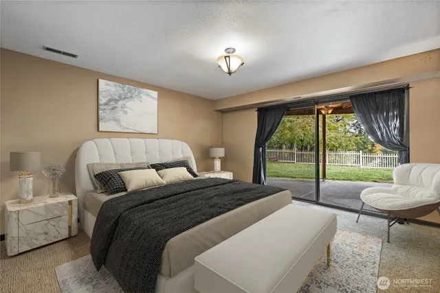 a bedroom with a bed and a large window with outer view