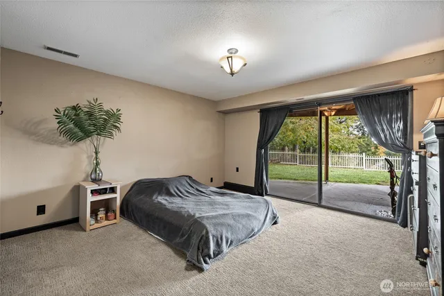 a bed sitting in a room next to a window