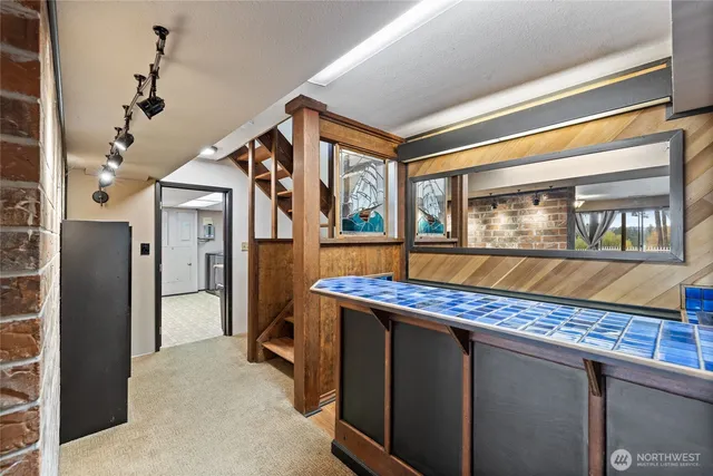 a living room with stainless steel appliances granite countertop furniture and a kitchen