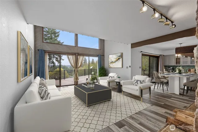 a living room with furniture floor to ceiling window and a table