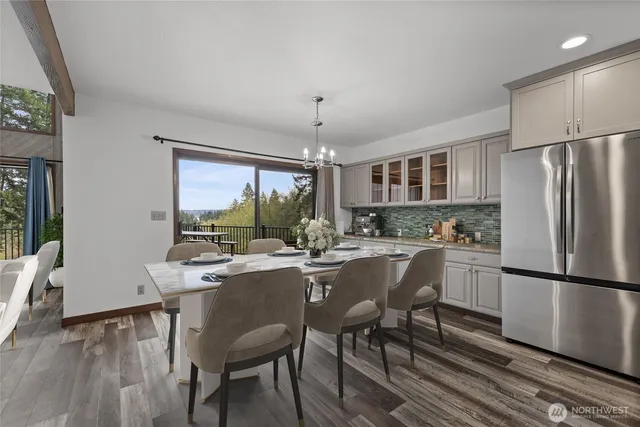 a kitchen with sink a refrigerator and chairs