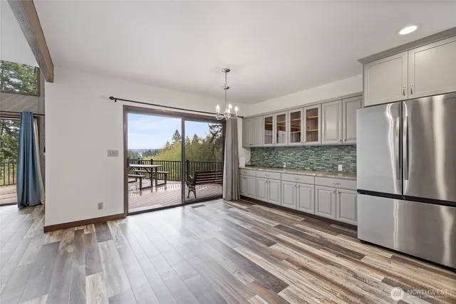 a kitchen with stainless steel appliances granite countertop a refrigerator and a sink