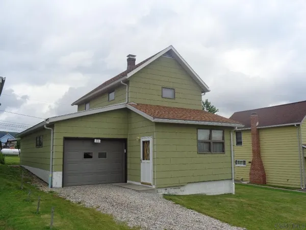 a house with green field in front of it