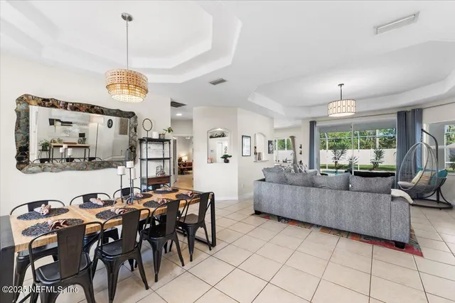 a kitchen with stainless steel appliances a stove a refrigerator and a white cabinets