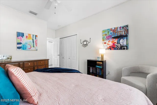 a spacious bedroom with a bed and a chandelier