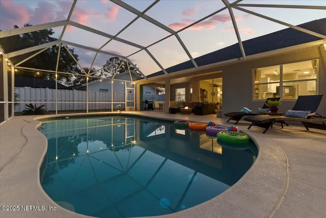 an aerial view of a house with swimming pool