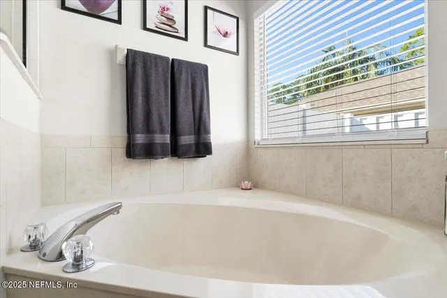 a front view of a house with a yard and potted plants
