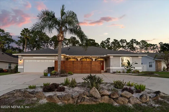a living room with patio furniture and a floor to ceiling window