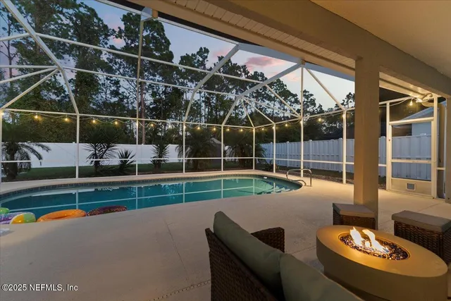 a living room with furniture a rug and white walls