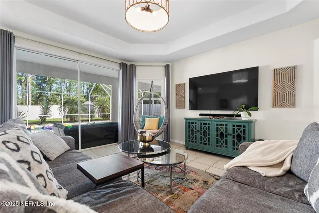 a view of a dining room with furniture large windows and wooden floor