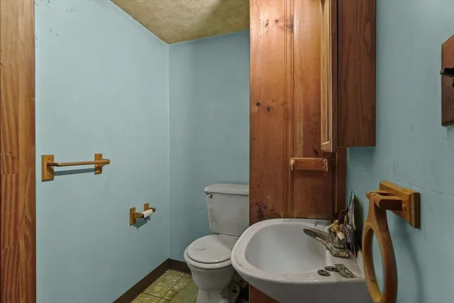 a bathroom with a sink a toilet and shower curtain